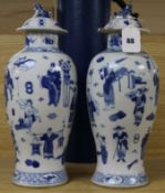 A pair of Chinese blue and white baluster vases and covers, decorated with figures, 37cm