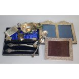 A silver mounted double photograph frame, a silver sauceboat, silver card case, silver vestas etc.