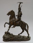 After Remington. A bronze group of a Native American warrior on horse back, signed in the bronze,