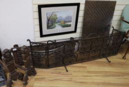 A three fold wire mesh spark guard, a pair of 17th century style iron fire dogs and a cast iron fire