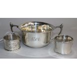 A George V silver porringer and two silver napkin rings.