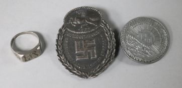 An original WW2 Kreigsmarine ring and two original WW2 German badges