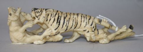 A Japanese carved ivory group of a tiger and two wolves, c.1900, 15cm