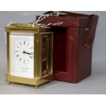 A Lionel Peck of London brass carriage timepiece, with travelling case, 12cm