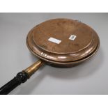 A Victorian copper warming pan