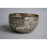 An Indian white metal circular bowl, chased with animals, 11.5cm.