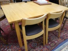 A modern beech extending dining table and four oak dining chairs 156cm x 100cm