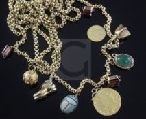 An early 20th century 15ct gold guard chain, hung with various charms including a George III spade