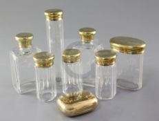 A George V Asprey & Co seven piece engine turned silver gilt-topped glass toilet set, London, 1920