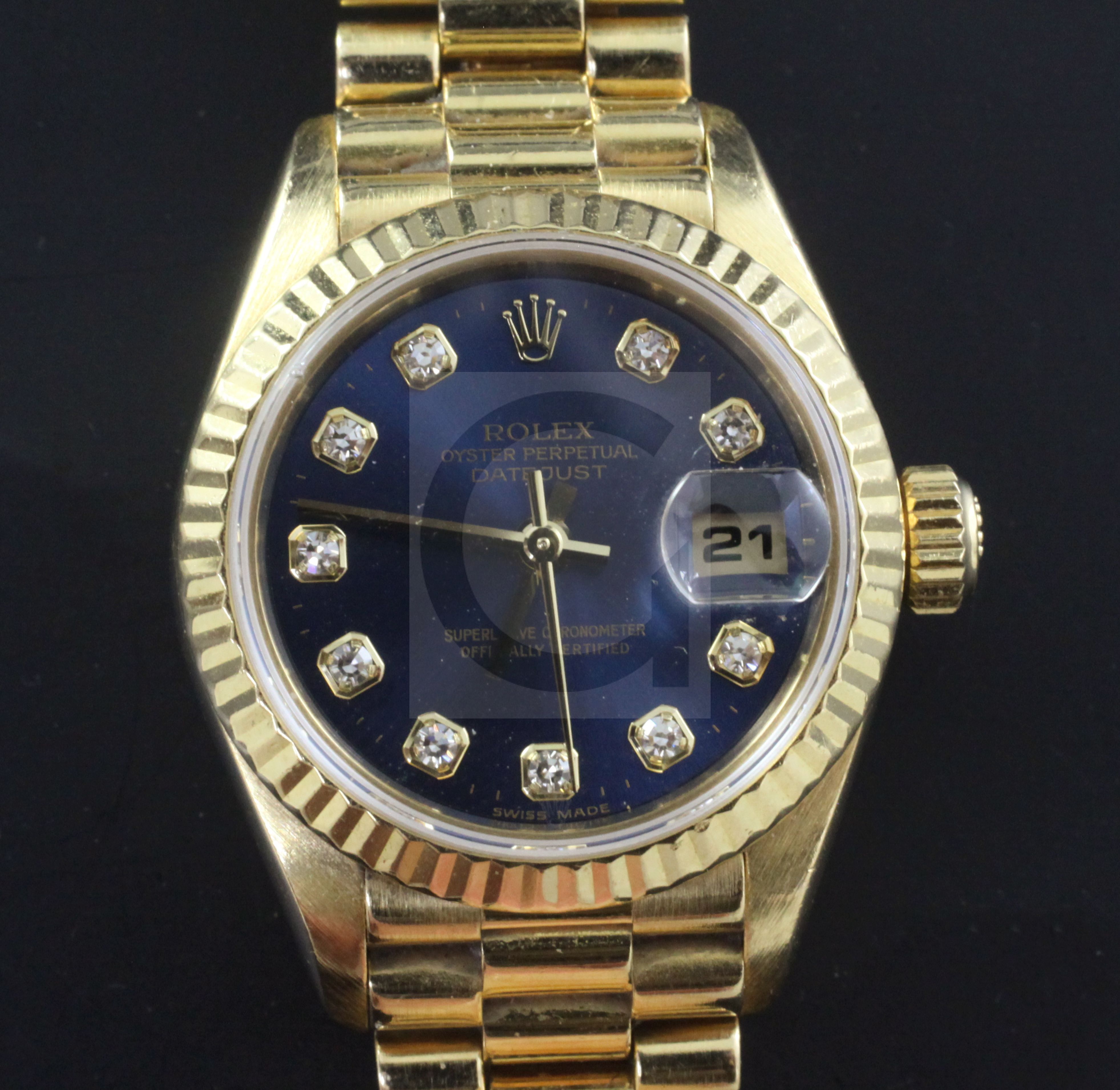 A lady's 18ct gold and diamond set Rolex Oyster Perpetual Datejust and box, the blue dial with