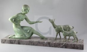 D.H. Chiparus. An Art Deco patinated bronze figure of a girl feeding goats, in stylised dress, on