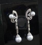 A pair of white gold diamond and Tahitian cultured pearl drop earrings, of scrolling design and