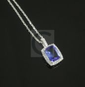 A modern 18ct white gold, tanzanite and diamond set pendant on an 18ct white gold fine link chain,