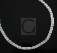 A modern 18ct white gold and diamond line bracelet. set with fifty round cut diamonds with a total