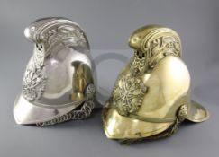 Two 19th century fireman's helmets, one nickel, the other brass, both with dragon crest and