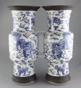 A pair of large Chinese blue and white crackle glaze vases each painted with lion-dogs with brocaded