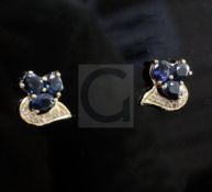 A pair of 18ct gold, sapphire and diamond cluster ear studs, of scrolling design, 11mm.From the