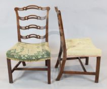 A set of eight George III mahogany ladderback dining chairs, with pierced spars, stuff-over seats