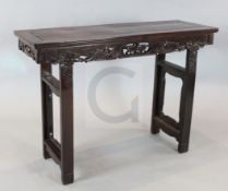 A late 19th / early 20th century Chinese hardwood altar table, carved and pierced with a butterfly