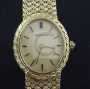 A lady's 18ct gold Jaeger Le-Coultre manual wind dress wrist watch, with oval dial and baton