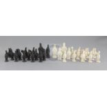 A Castleford type biscuit porcelain and basalt chess set, modelled as opposing armies, kings 3.