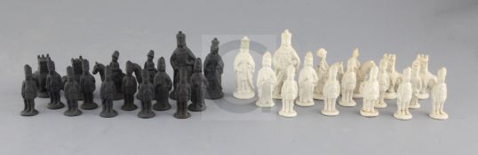 A Castleford type biscuit porcelain and basalt chess set, modelled as opposing armies, kings 3.