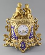 A mid 19th century French porcelain mounted ormolu mantel clock, the demi-lune case with fruiting