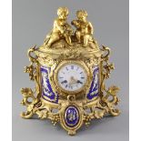 A mid 19th century French porcelain mounted ormolu mantel clock, the demi-lune case with fruiting