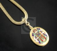 A Victorian high carat gold mourning pendant locket with polychrome enamelled monogram, on a snake