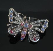 A Victorian gold and silver, sapphire, ruby and rose cut diamond set openwork butterfly brooch,