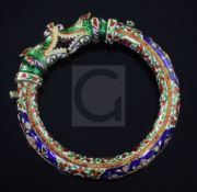 An Indian gold, enamel and multi gem set bangle, with twin dragon's head terminal.