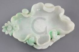 A Chinese jadeite 'lotus leaf' brushwasher, the ice white stone with emerald green inclusions,