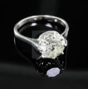 A modern platinum and solitaire diamond ring, the round brilliant cut stone weighing approximately