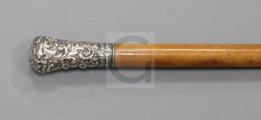 A Victorian silver knopped malacca cane, the handled decorated with a mask and repousse scrolls