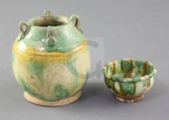 A Chinese Sancai four handled jar and a similar cup, Tang dynasty (618-906AD), both with unglazed