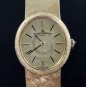 A lady's 18ct gold Baume and Mercier manual wind wrist watch, with textured oval dial and baton