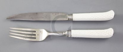 A Saint Cloud or Mennecy white glazed porcelain pistol handled knife and fork, c.1740-60, with