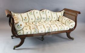 A Regency mahogany campaign settee, with caned back, sides and seat, and floral pattern squab