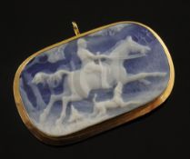 An Italian 18ct gold mounted blue jasper brooch carved with horse and rider in hunting scene, 49mm.