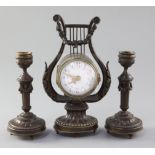 An early 20th century French patinated bronze garniture, the timepiece in lyre case, with 2.25