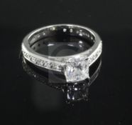 A modern platinum and single stone diamond ring with diamond set shank, with accompanying IGI