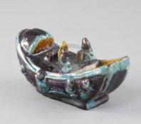 A Chinese Ming Fahua boat water dropper, 16th century, modelled with three figures on deck, unglazed