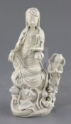 A Chinese Dehua blanc de chine group of Guanyin and an attendant, the figure holding a lotus sprig