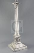 A 20th century silver plated corinthian column table lamp, the pedestal decorated with laurel