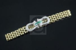 An 18ct gold, emerald and diamond set bracelet, with gem set horseshoe shaped clasp.