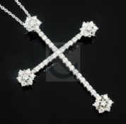 A modern white gold and diamond set cross pendant on and 18ct white gold chain, pendant 61mm.