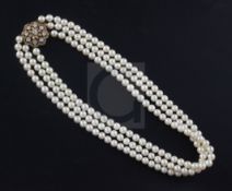 A 1980's triple strand cultured pearl choker necklace with 18ct gold and diamond cluster set
