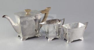 A 1930's silver three piece tea set by Stower & Wragg, of shaped rectangular form, with engraved