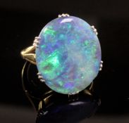An 18ct gold and platinum set oval black opal dress ring