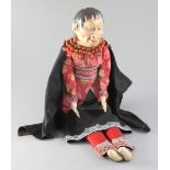 A Native American doll, with composition head, kid leather hands and beadwork borders to costume,
